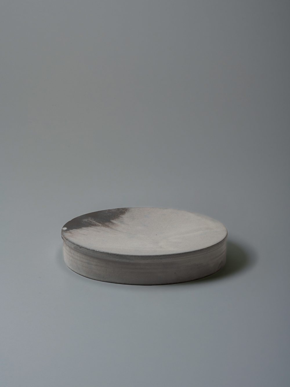 8.5 Elevated Plate<br />Wood ash and white liquid clay glaze